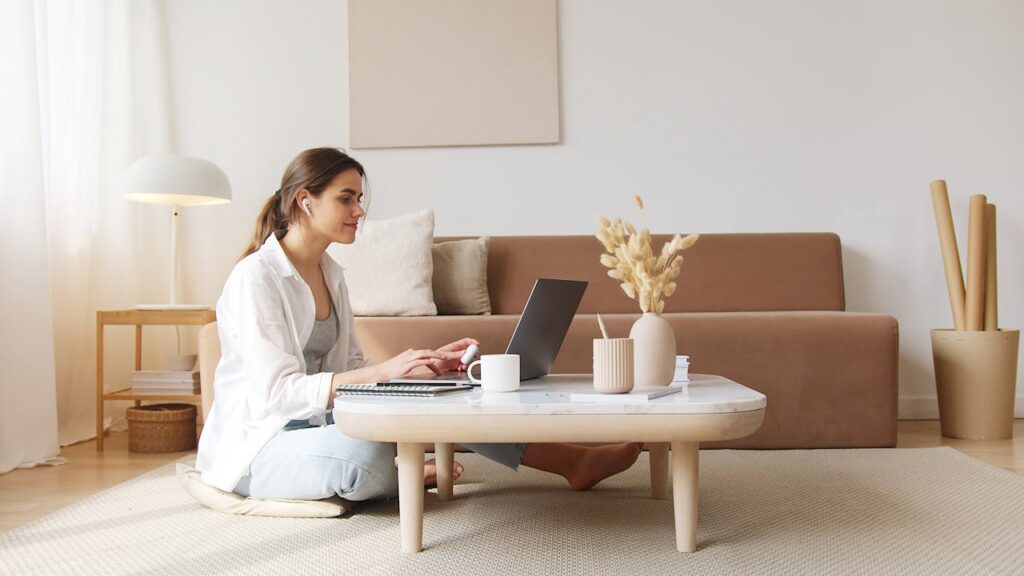 Content woman using laptop on floor